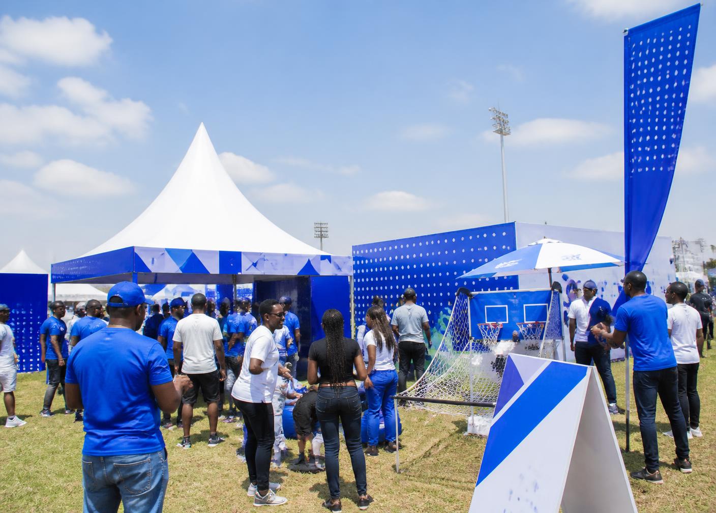 Fans engaging with a branded activation zone at an outdoor sports event